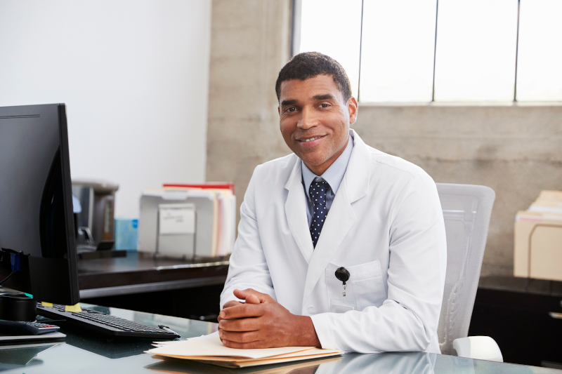 Mixed race  male doctor at desk, portrait